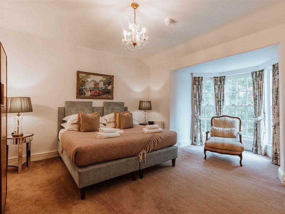 Bedroom Two is a spacious double room on the first floor dominated by the wonderful super king-size bed. There is bay window with a comfy chair to