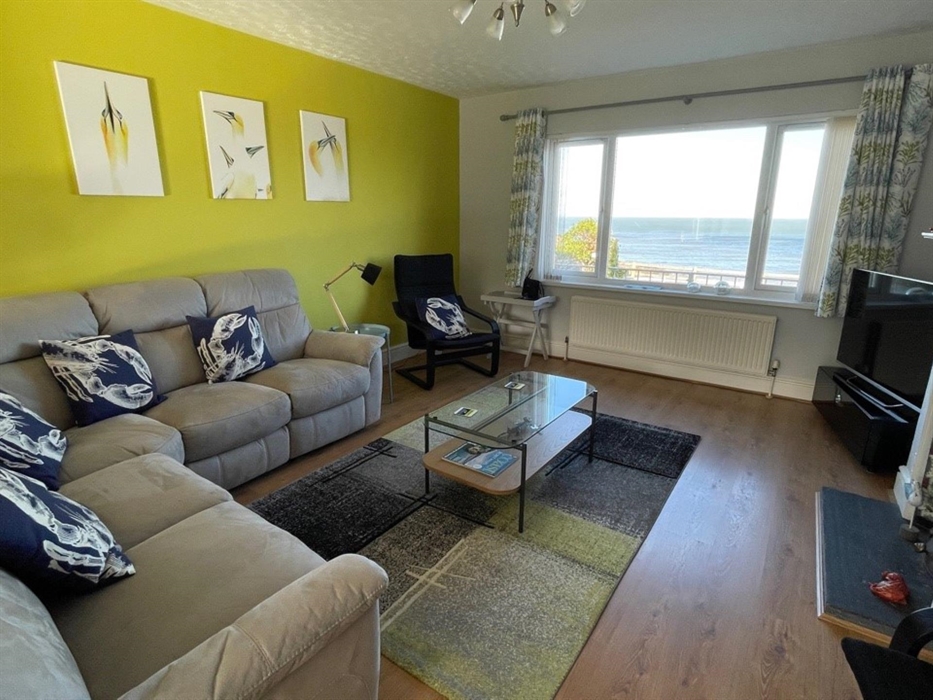 Comfortable lounge has stunning sea views and recliner sofa.