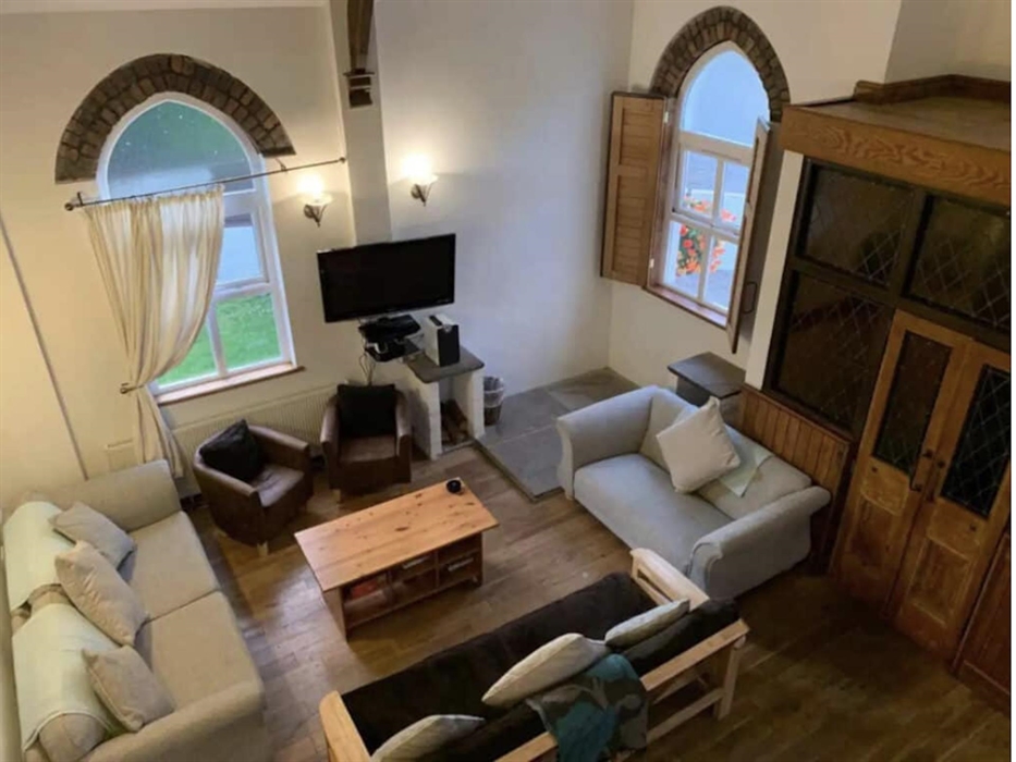 Spacious Lounge with vaulted ceiling, exposing beams and original roof ties of the chapel. All ground floor doors are widened and have wheelchair acce