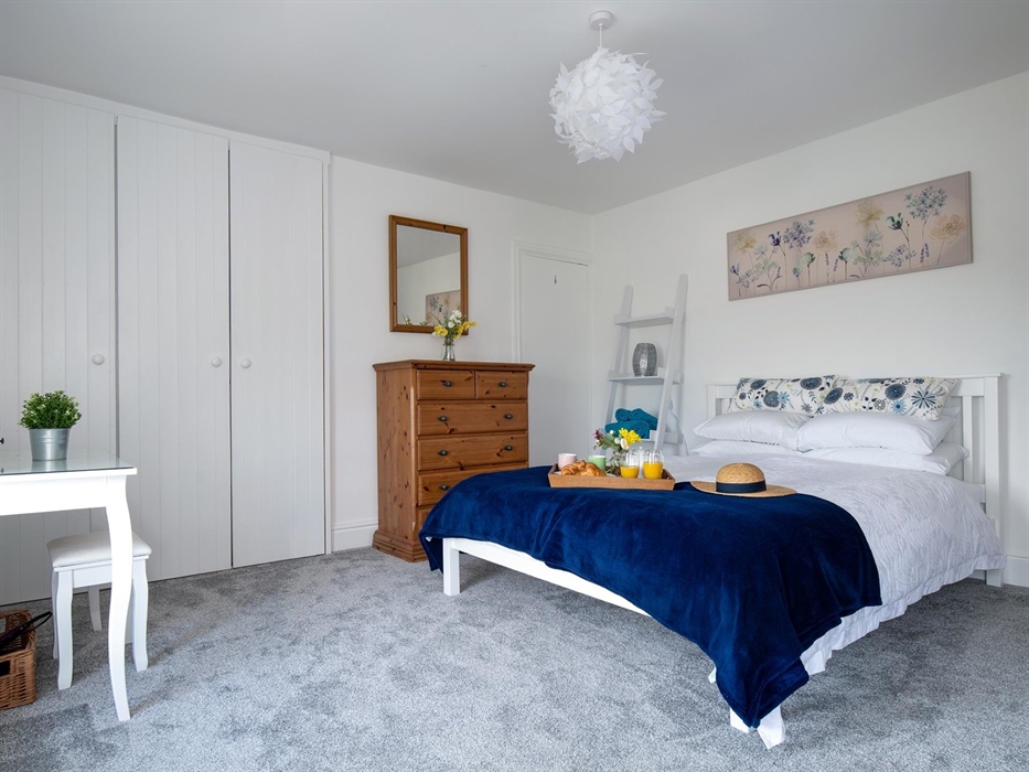 This photograph shows the spaciousness of the main bedroom