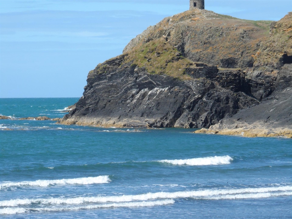 The waves spill on to the beach below Abereiddy's iconic tower.