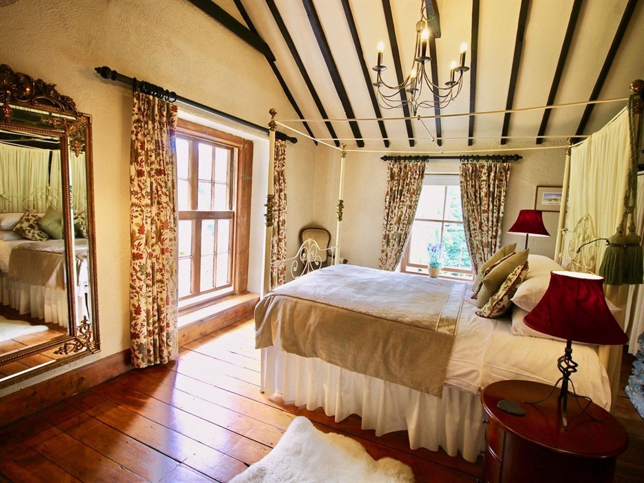 Master bedroom with original iron bed.  high vaulted ceiling and original sash window with breathtaking views of the Gwydir forest and the Lledr Valle