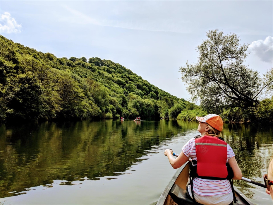 Adult canoeing in a river