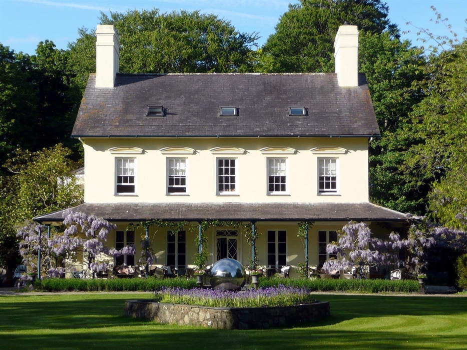 Stunningly beautiful Grade 2* listed Georgian Manor house with a Wisteria clad verandah and  5 acres of gardens on the Llyn Peninsula.