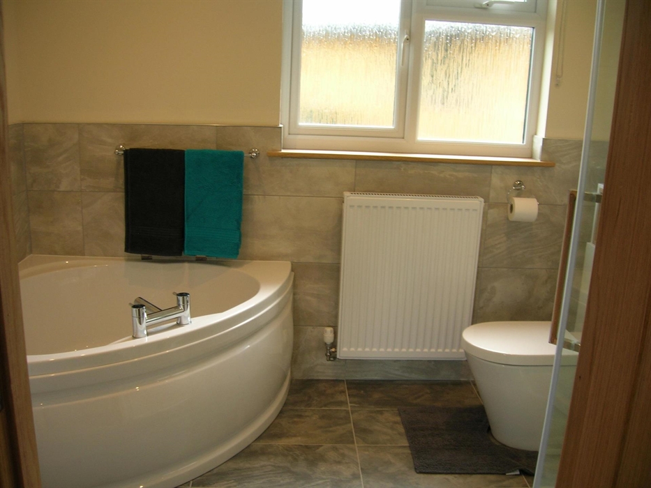 The main Bathroom has a Bath, shower, Toilet and Washbasin.