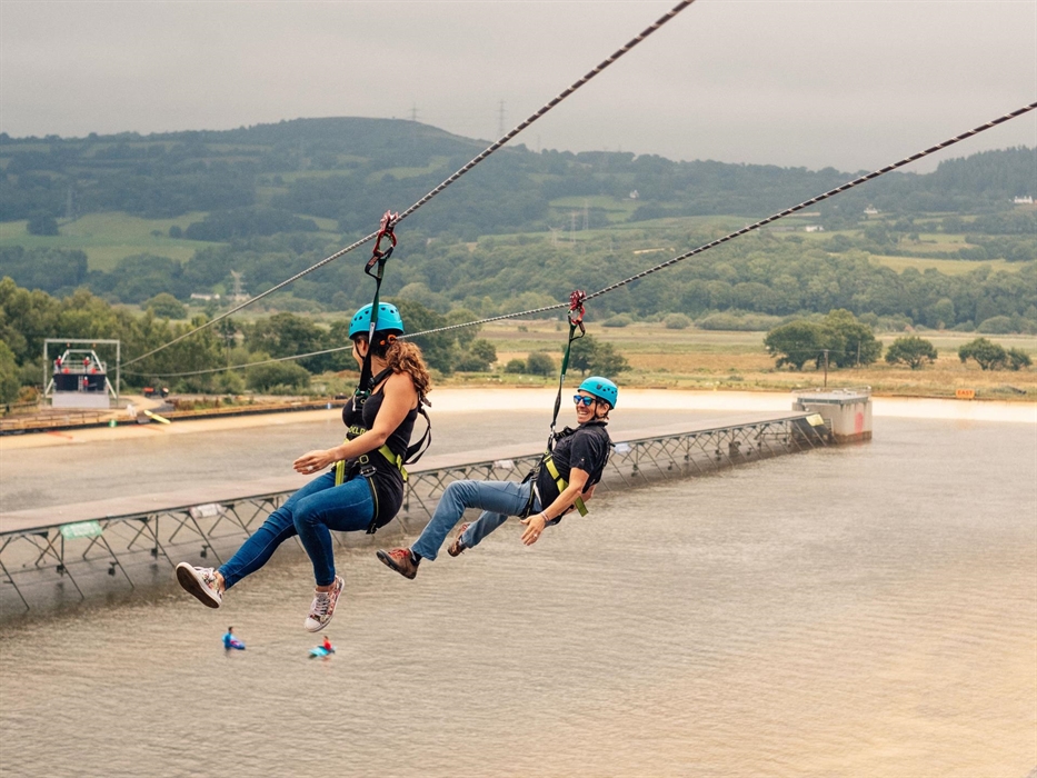 Zip over the heads of surfers on a tandem ride