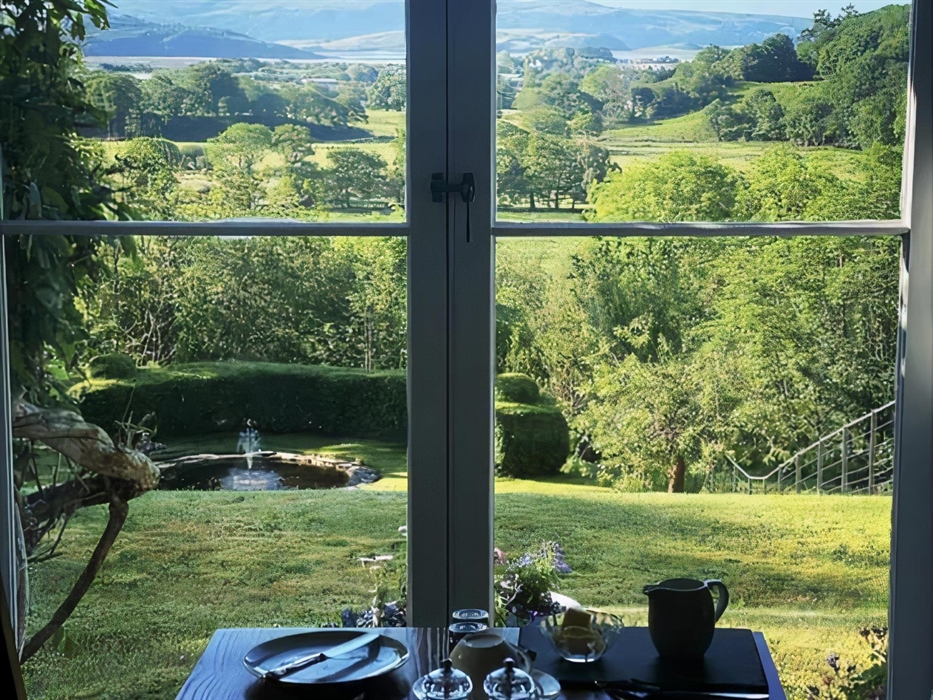 Guests take breakfast in the Dining Room with spectacular views over the Glaslyn Estuary to the sea and Rhinog mountains beyond.