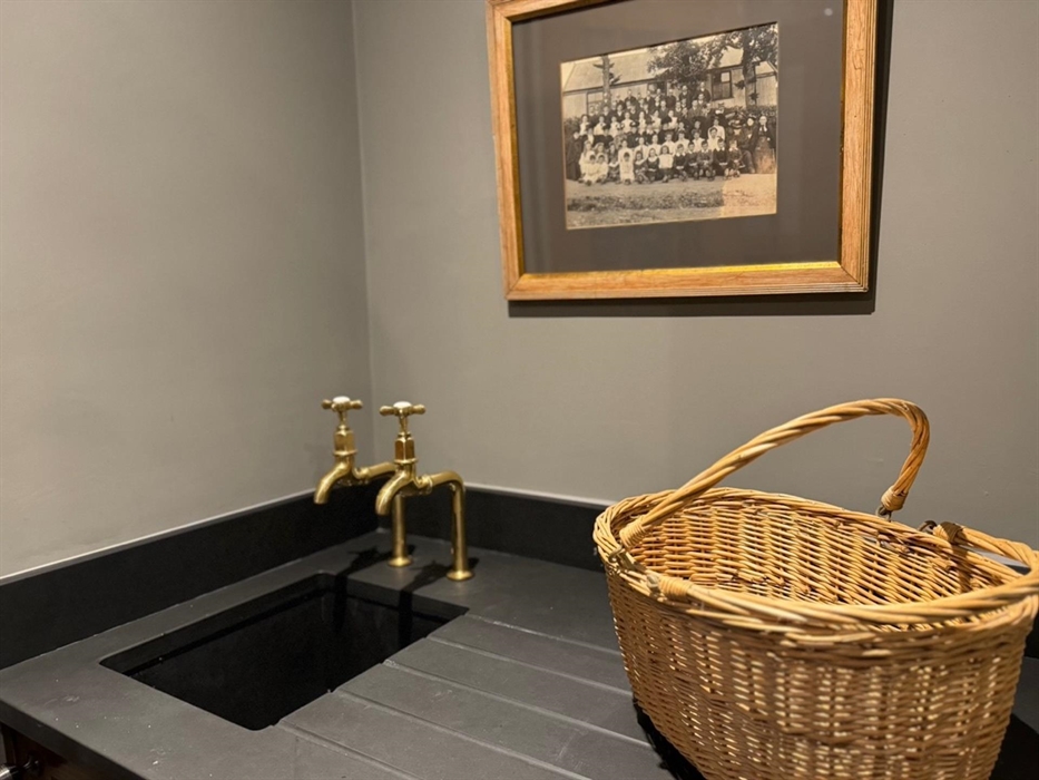 Utility Room at Coedfa Bach with sink/drainer, washer dryer, storage cupboard, hanging cupboard, drying rack