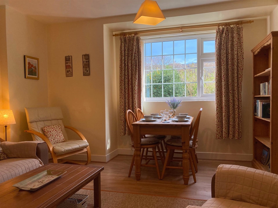 Comfy lounge and dining room. Dining table with view of the mountains