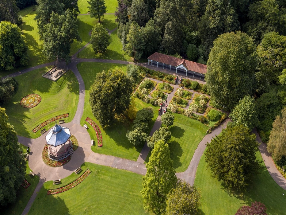 An overhead shot of the grounds of the park featuring the bandstand and the long shelter.