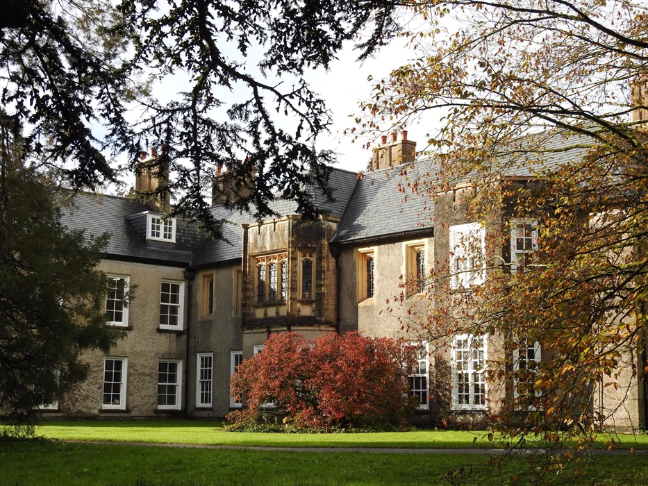 The exterior of Old Bishop's Palace surrounded by trees and shrubs