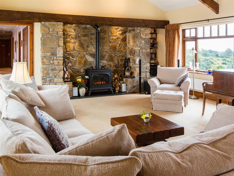 Music room; corner settee, fireplace and piano.