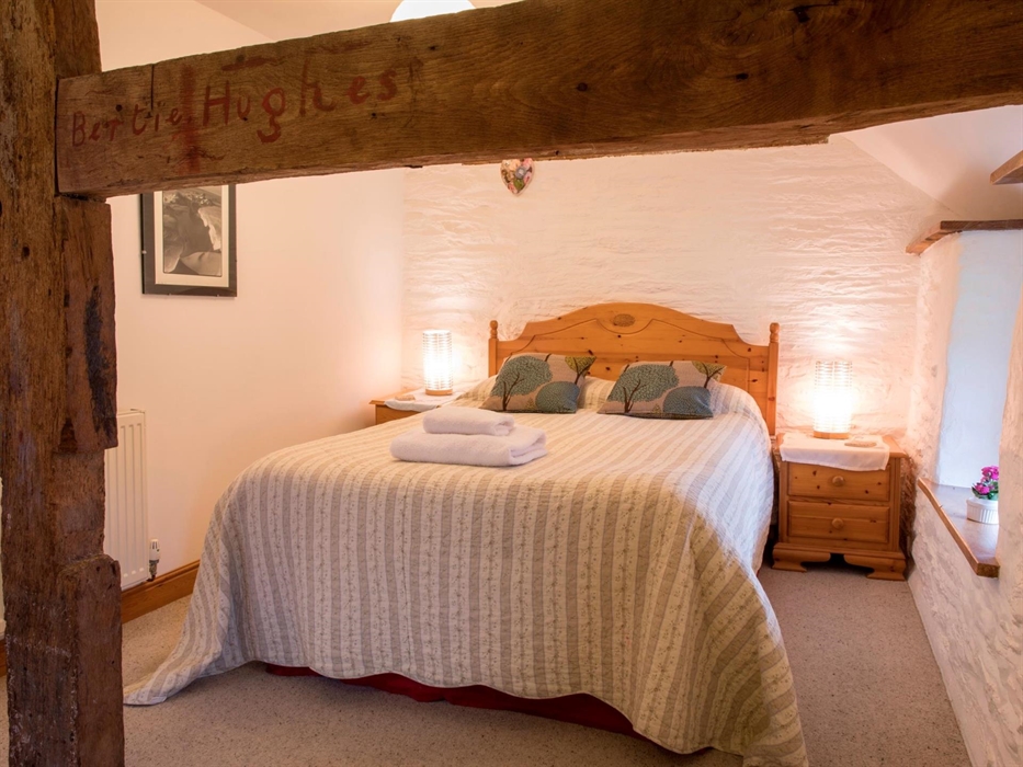 Sleep soundly in this comfy bed in the Granary self catering cottage, looking out over the meadows at Nannerth Fawr Farm.