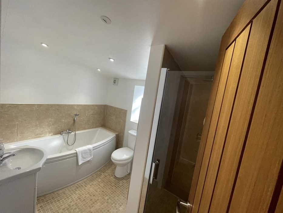 with separate walk-in shower cubicle, bath with shower attachment, toilet & sink