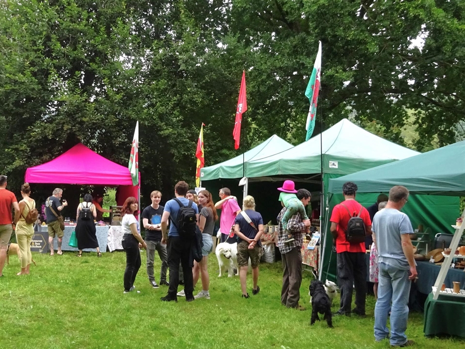 Colourful stalls selling local produce with people shopping.