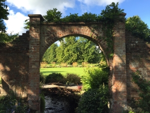 The archways into the Round garden frame many unusual and attractive views - this one towards the Stipa gigantea which catch the morning and evening s