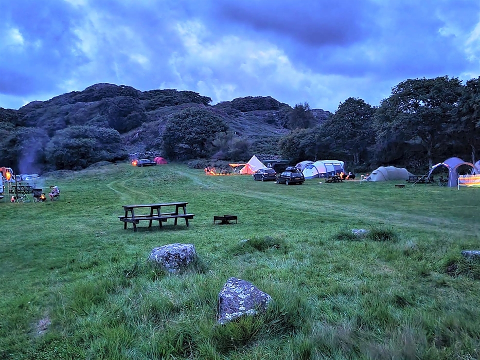 camping field with tents and campfires