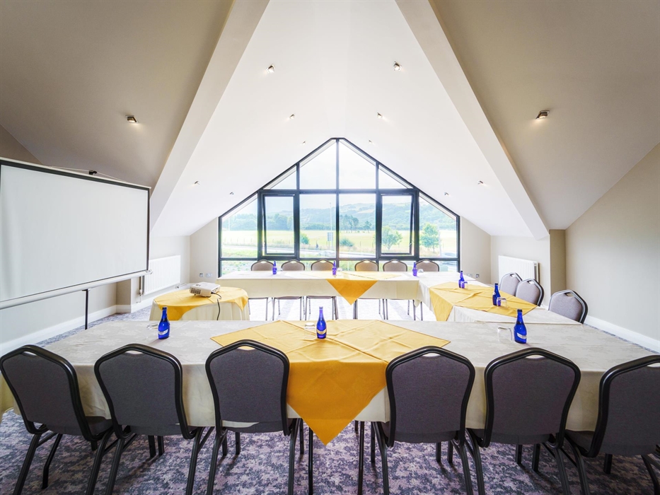Room with a view over greenery featuring tables and chairs in a square formation, at Park Lodge Hotel
