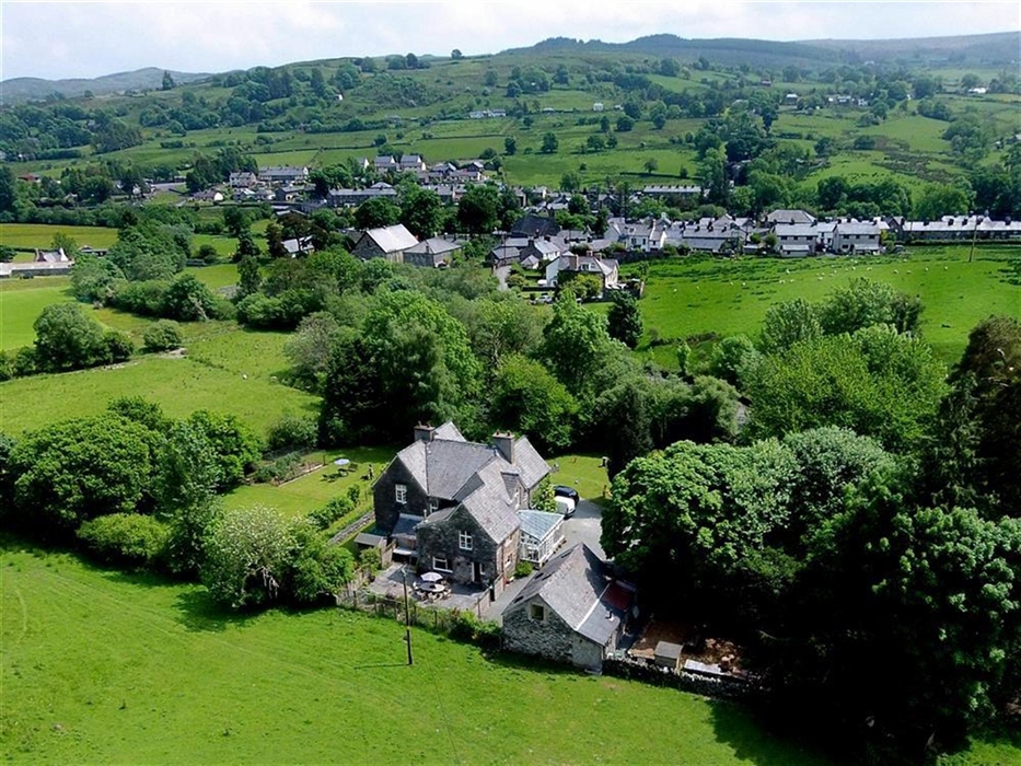 The Coach House with the village of Penmachno in the background. A beautiful location in the Penmachno Valley, near to Betws-y-Coed and within the Sno