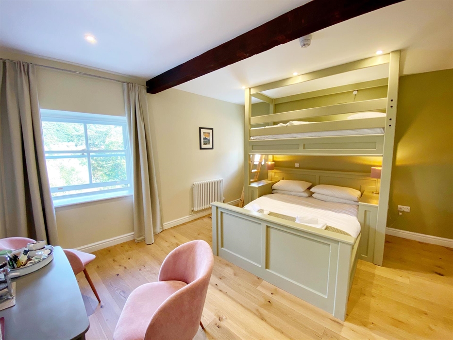 Our triple room has a bespoke bunk bed that sleeps 3 in a king-sized bed and a single bed over.