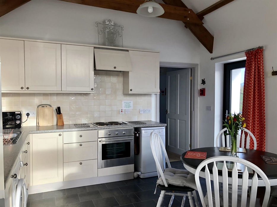 Everything you need in bright kitchen with electric hob and oven , microwave, toaster, kettle , dishwasher and fridge freezer