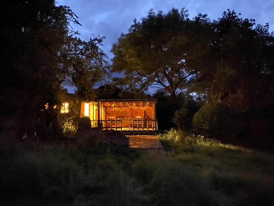 The yurt kitchen at Strawberry Skys Yurts with lights glowing in the night.