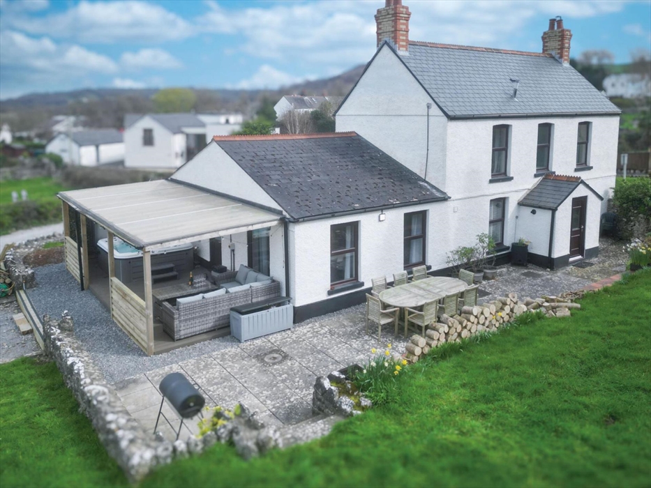 South facing terrace with eight seater dining table, parasol and charcoal BBQ.