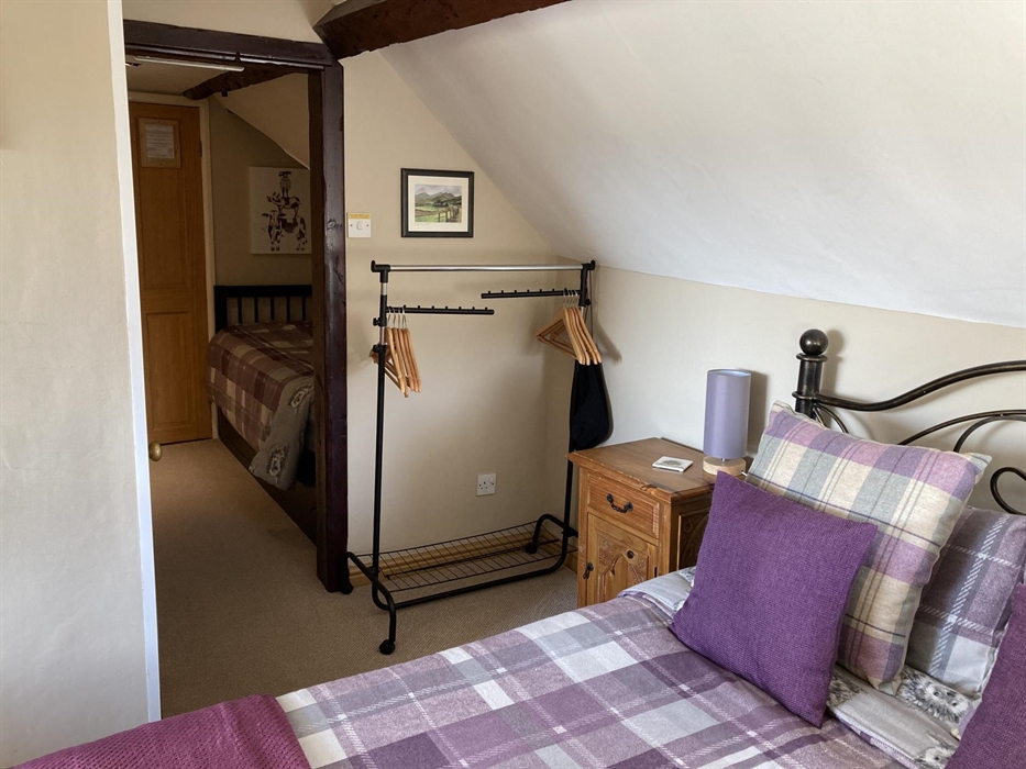 Double room plus a single bed with ensuite shower.  Over looking to the Snowdonia Mountain Range to the side, the small window looks across to the fie