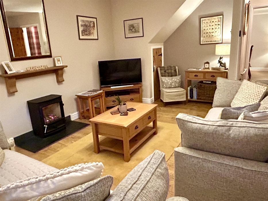 Cosy lounge with smart TV and log effect gas fire.