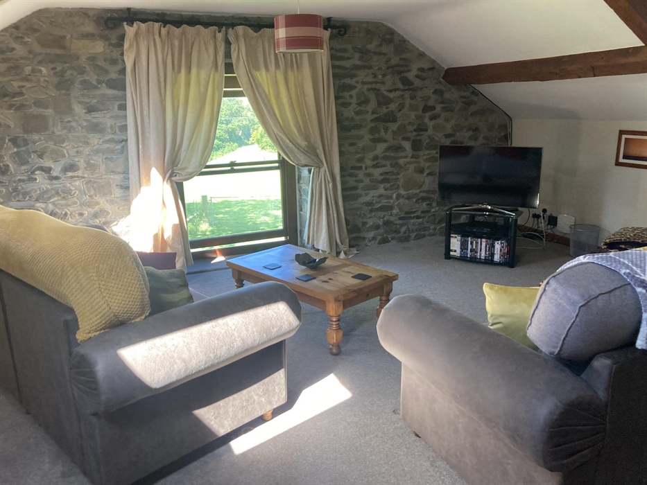 The whole of the upstairs is devoted to the lounge.  Smart TV, views down the valley, warm and comfortable