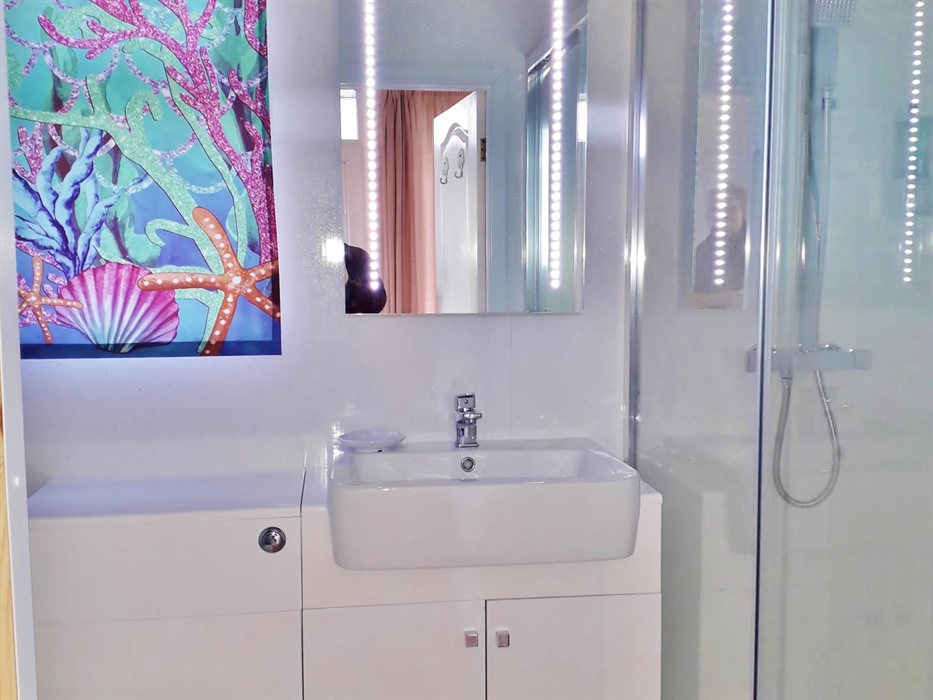 As you will see, Sea Moss Cabin has beautiful modern bathroom furniture and decor.