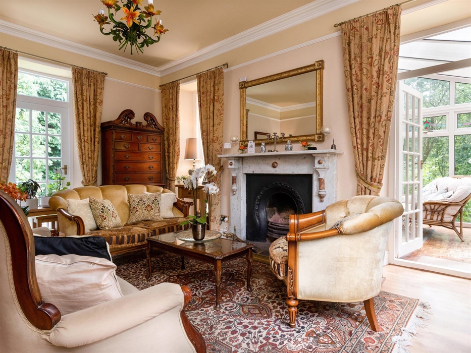Afon Rhaiadr Country House is a 5-star Victorian B&B in Snowdonia, set in nature. Relax with a drink in the stylish sitting room by a cozy wood fire.