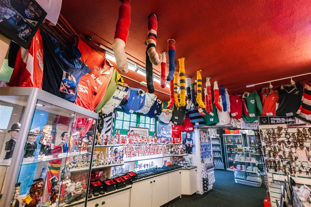 The photo shows a wide shot of the shop, with rugby socks hanging from the ceiling.