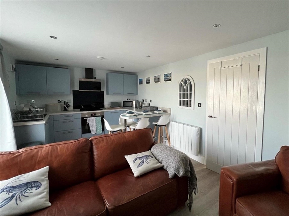 Lounge with 50 inch smart TV and comfortable seating area. Games and quizzes are provided for some quality family time