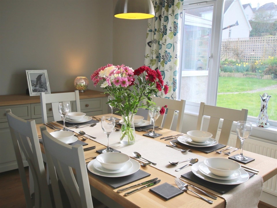 Stylish dining area has views over the pretty back garden as well as views to the sea.