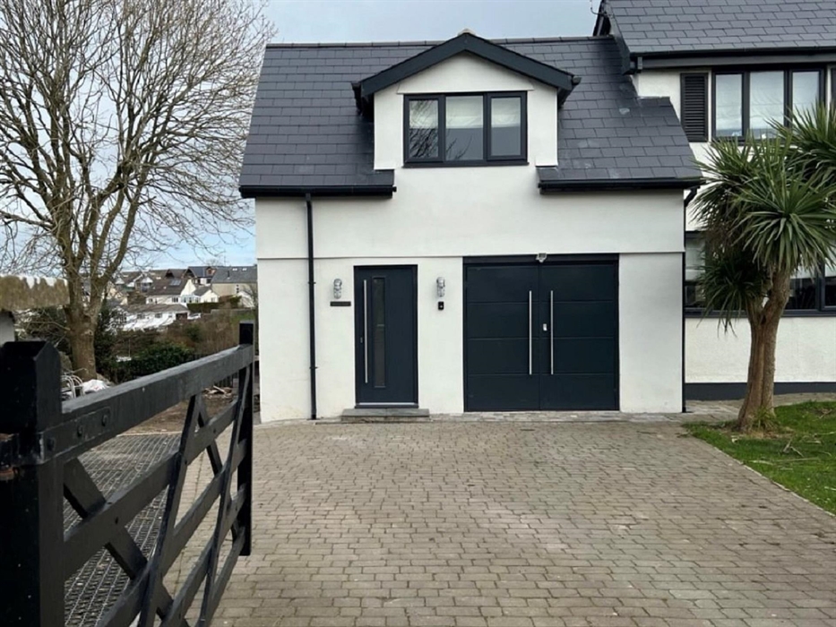 Entrance to the lodge with private parking for 2-3 cars. A garage with lockable storage for bikes/surf boards is available for guests.
