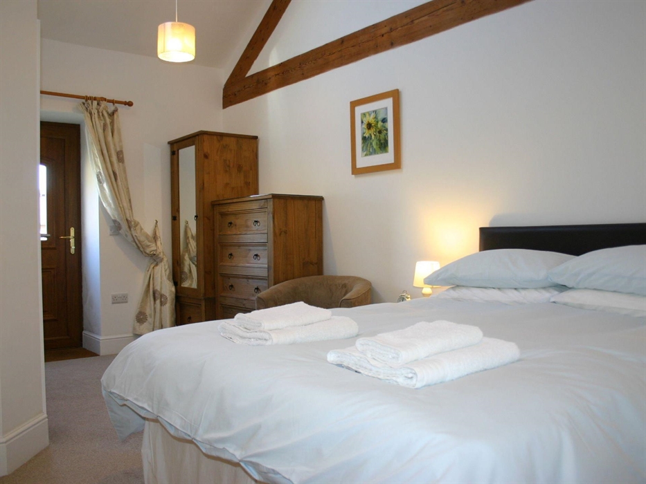 with 5' king bed, en-suite shower room & door onto the external decking