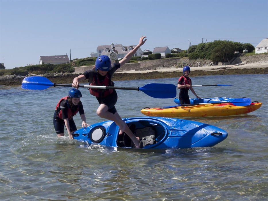 young people having fun in kayaks, Rhoscolyn