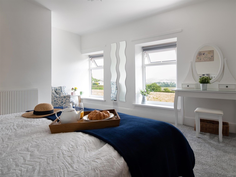 This large and bright room also has a comfortable armchair.  Ideal for sitting with a drink and a book while you take in the view