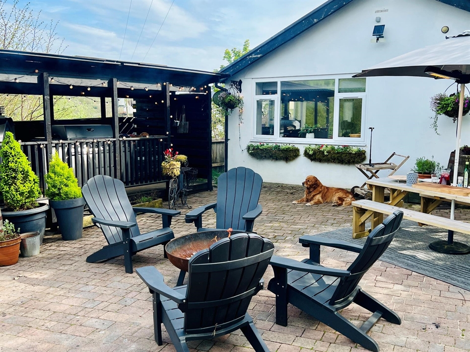 A large private patio with outdoor kitchen which includes a large wood fired pizza oven and gas BBQ. Parking for up to two cars.