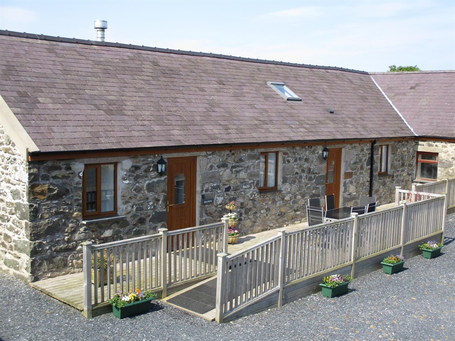 Delfryn's external decking area is accessed via the slope or steps