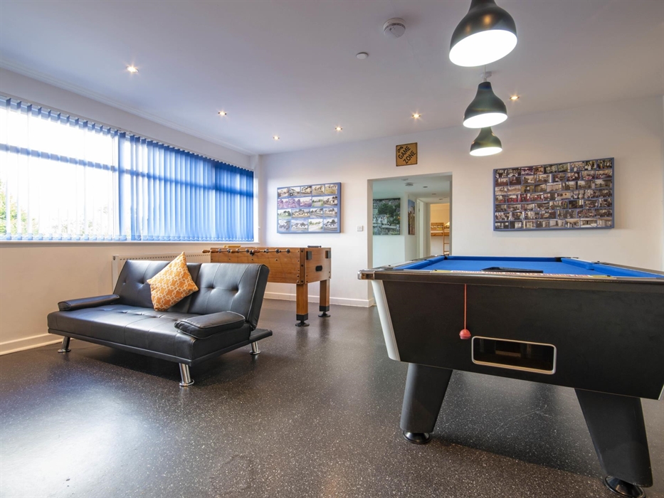 Welsh Row House games room. Seats in front of Xbox with Xbox games Pass.  Football Table and Pool Table leading through to bedrooms all on one level.
