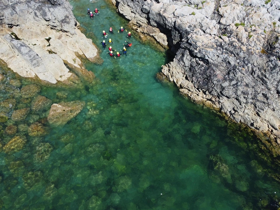 Coasteerers begin their adventure in clear water.