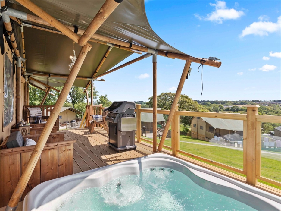 With view of hot tub, deck, BBQ and countryside.