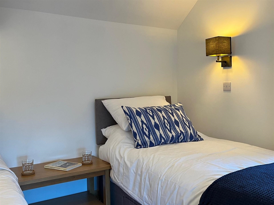 The second bedroom includes two single beds