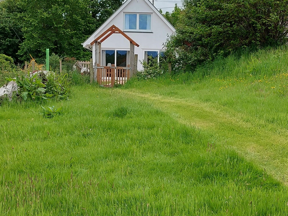 Stroll out through the arched gate to the lush lawn beyond - perfect for a picnic!
