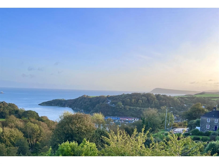 This view from bedroom 5 is sunrise over towards north Wales. Fishguard Lower Town is in the foreground leading to Fishguard Fort, Dinas Head and Card