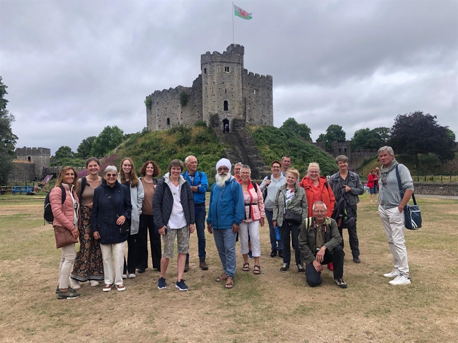 A group of adults standing in front of the Norman keep at Cardiff Castle