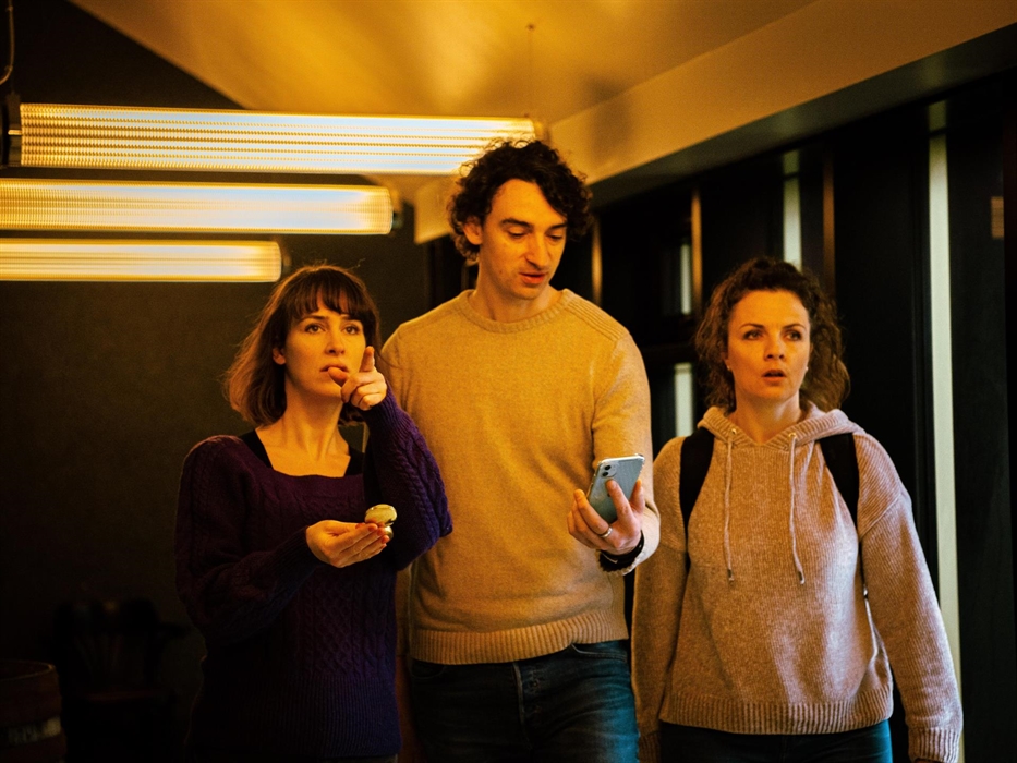 Team using their digital device guide them to their next destination.