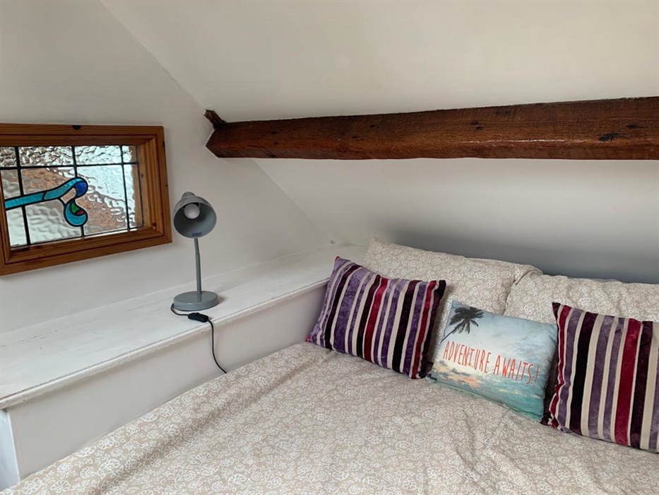 Upper floor room, with inset double bed and a Velux window